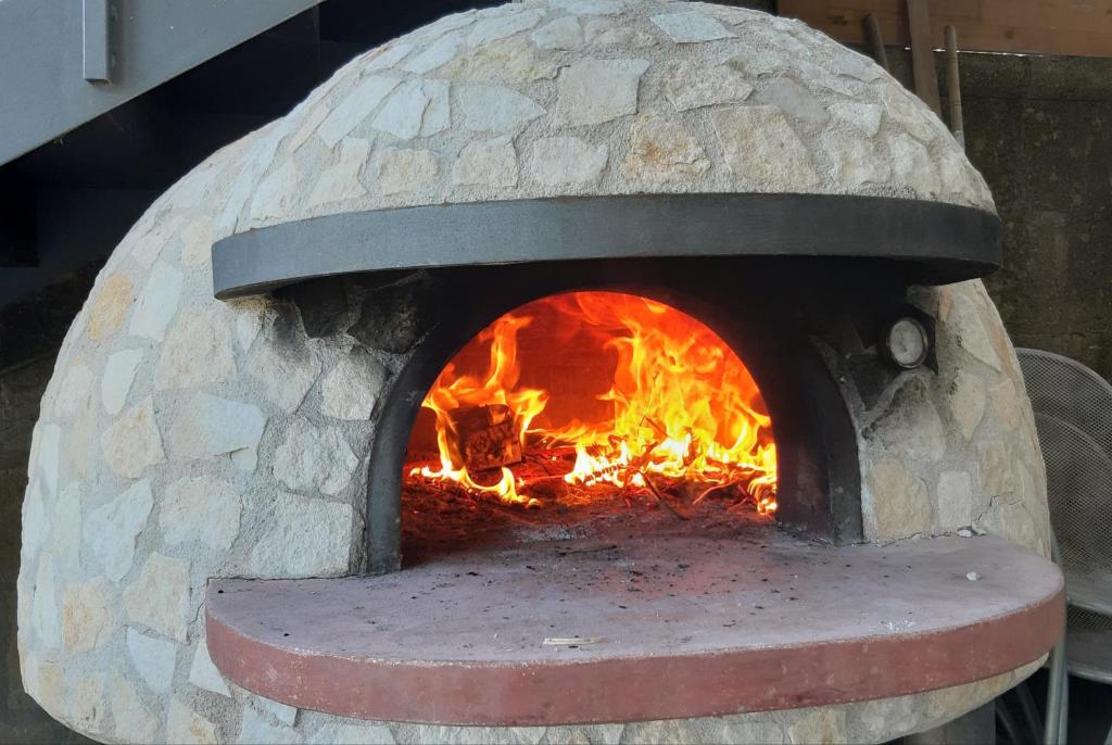 a stone oven with a fire in it at Il Profumo di Capri in Massa Lubrense
