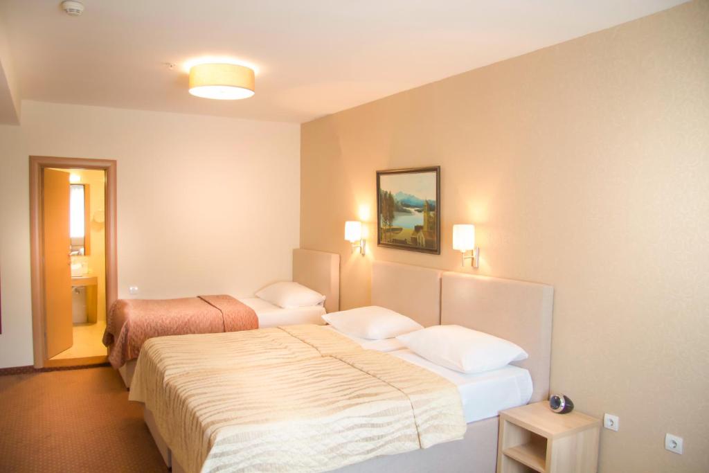 Postel nebo postele na pokoji v ubytování Philia Hotel