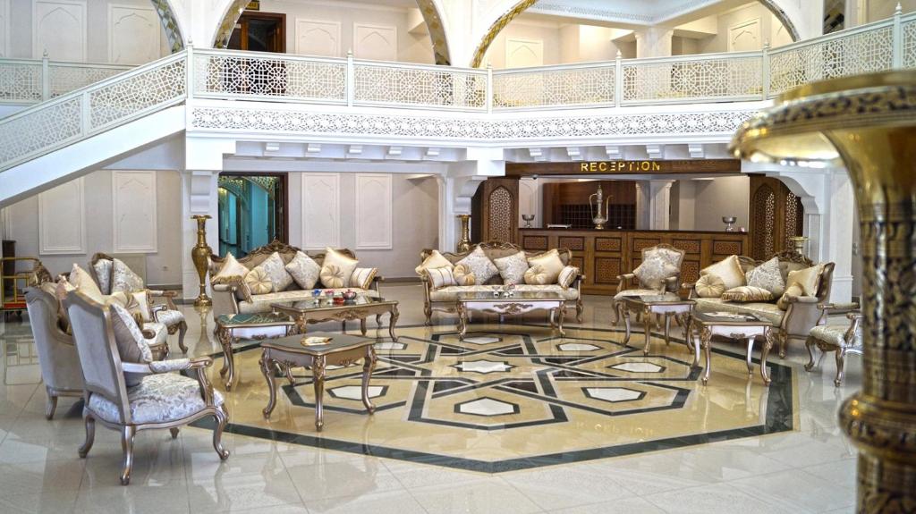 a living room with a lot of chairs and tables at SHAHRISTAN Plaza in Bukhara