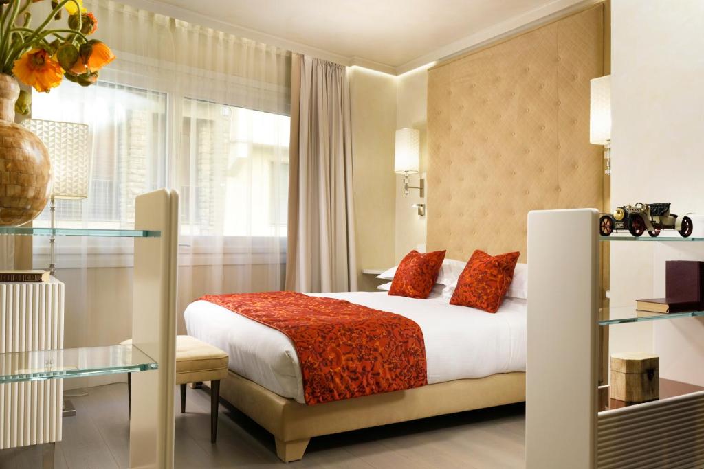 Postel nebo postele na pokoji v ubytování Ponte Vecchio Suites & Spa