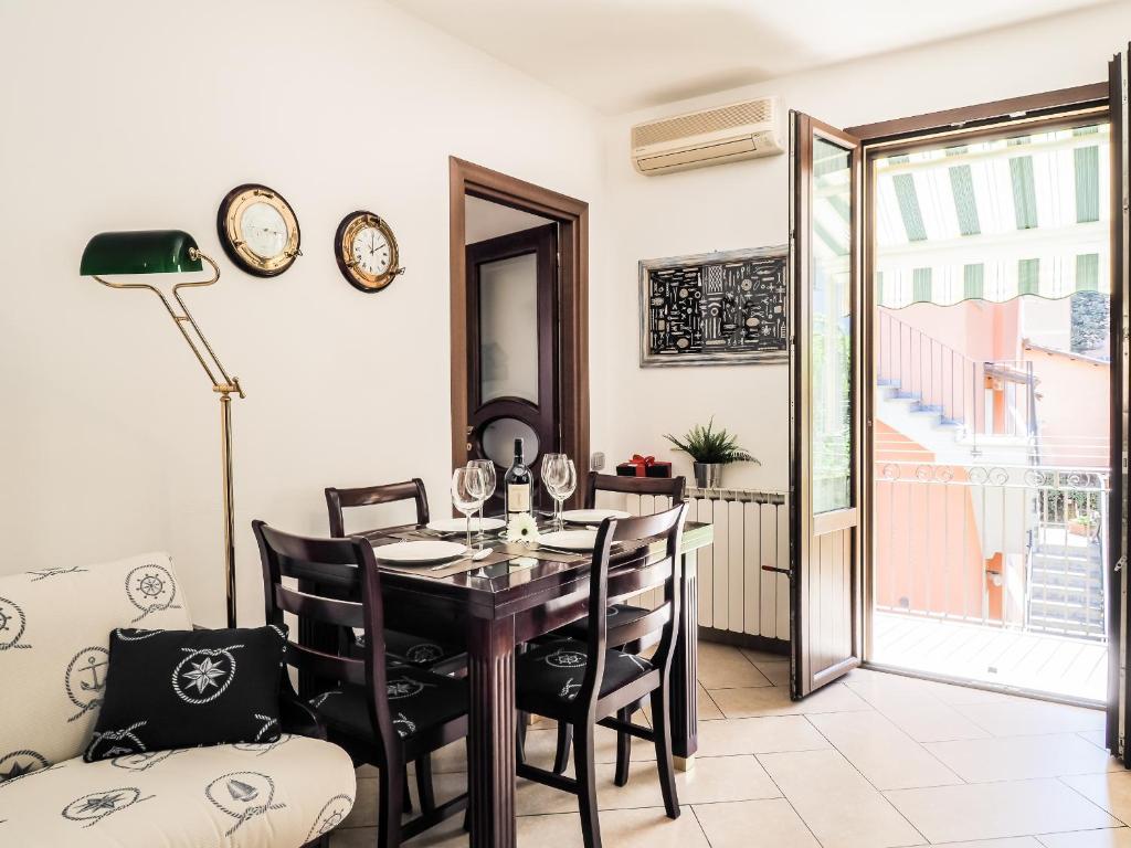 een eetkamer met een tafel en stoelen en een raam bij La Strada al mare in La Spezia