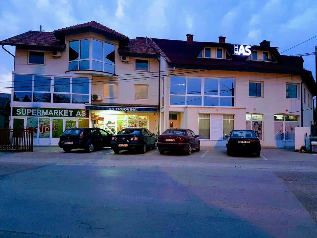 a group of cars parked in front of a building at Apartments AS Dubrave in Dubrave Gornje