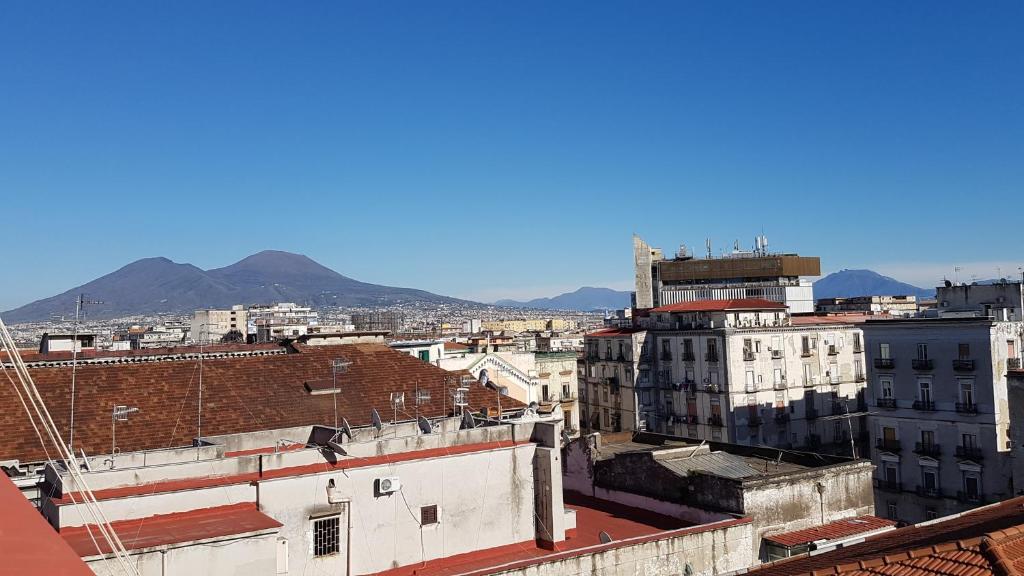 a city with buildings and mountains in the background at Il Balconcino in Naples