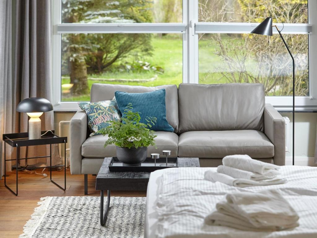 a living room with a couch and a large window at Düne 6 in Sankt Peter-Ording