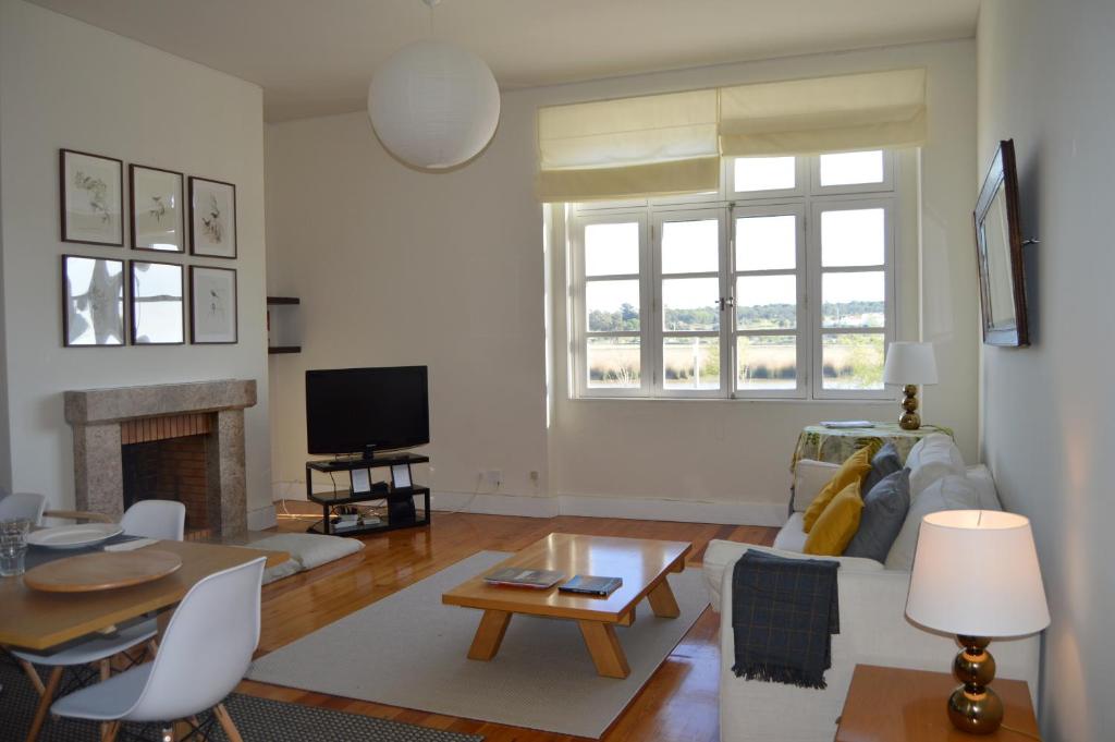una sala de estar con un sofá y una mesa en Alcacer River Apartment, en Alcácer do Sal