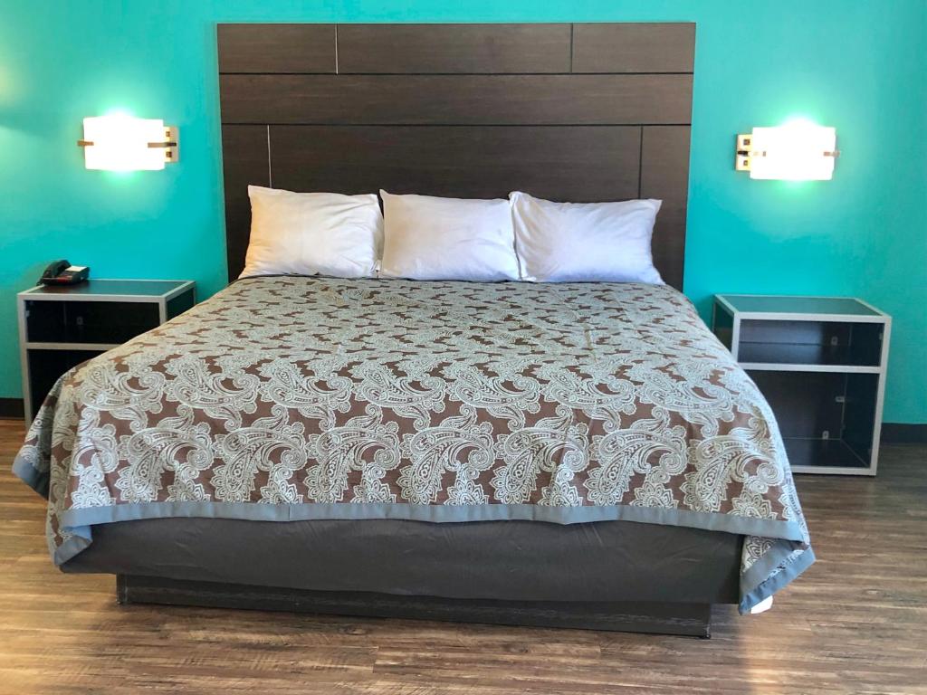 a bedroom with a large bed with two night stands at Euro Inn & Suites of Slidell in Slidell