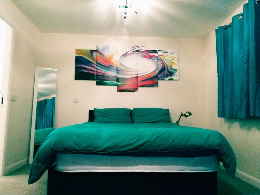 una camera da letto con un letto e un dipinto sul muro di Longford Street, Derby a Derby