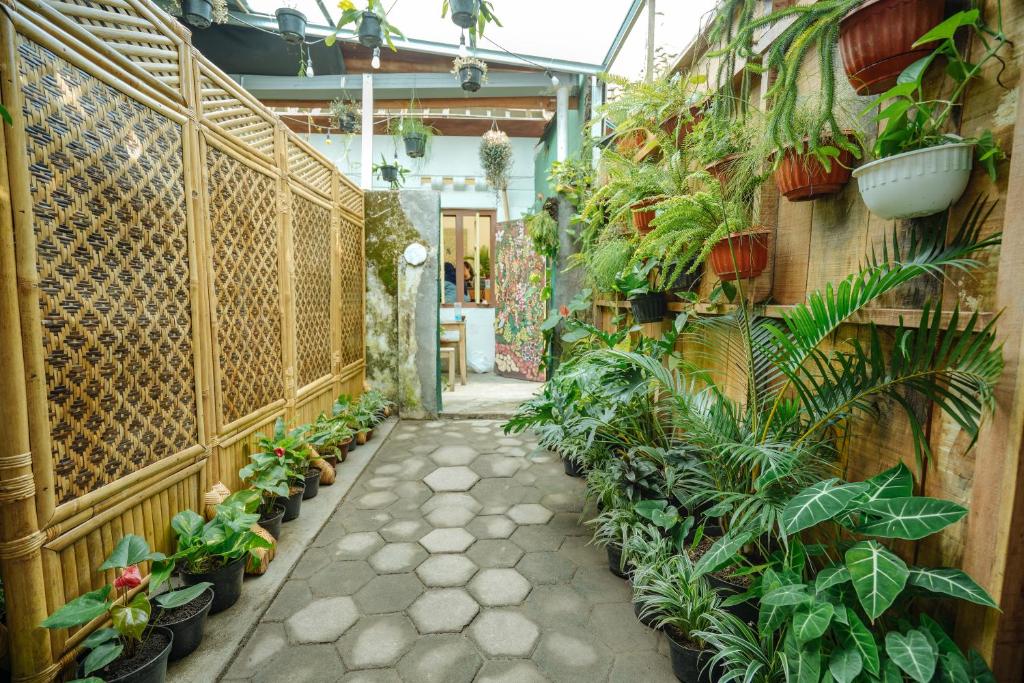 a hallway filled with lots of plants in a building at Snooze in Yogyakarta