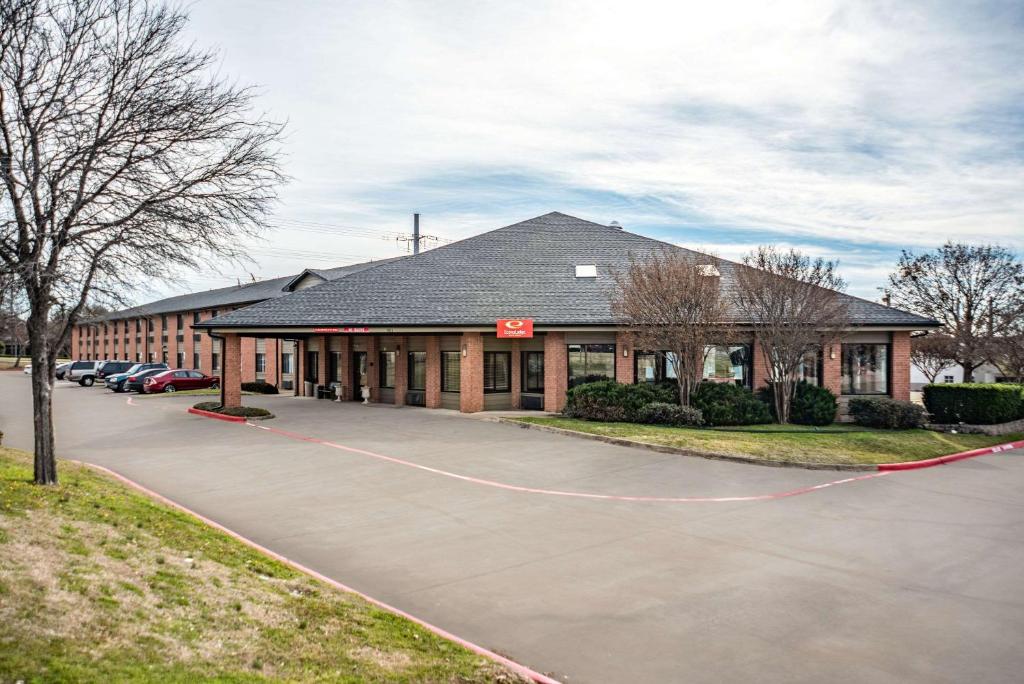 a building with a parking lot in front of it at Econo Lodge Inn & Suites in McKinney