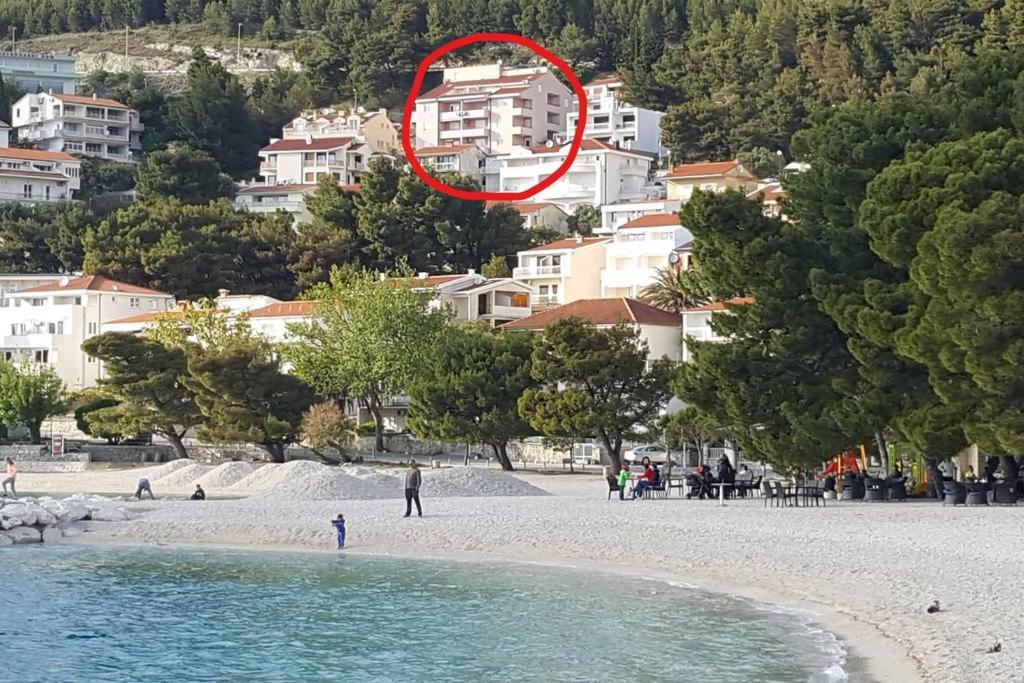 a person standing on a beach with a red circle at Apartment Fanny in Baška Voda