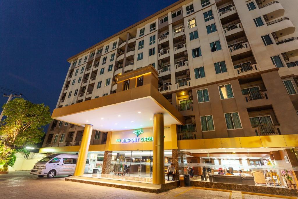 a building with a store in front of it at The Airport Greenery Hotel in Chiang Mai