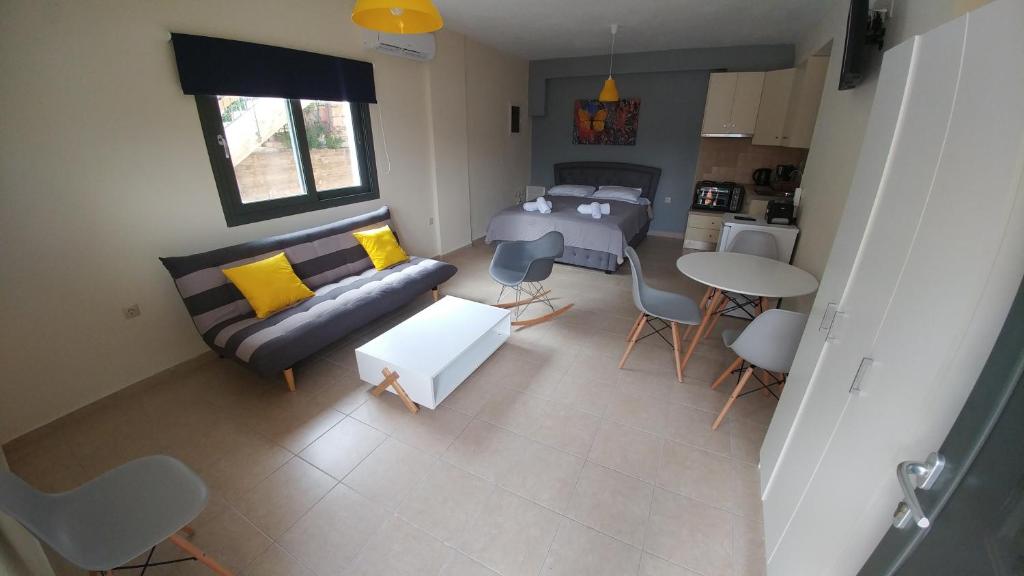 a living room with a couch and a bed and a table at Argostoli bay view in Argostoli