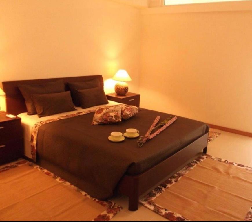 a bedroom with a large bed with a table at Villa contemporaine in Yaoundé