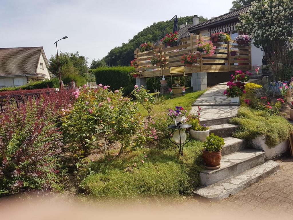 a garden of flowers and plants in front of a house at VOLCANS D'AUVERGNE - PONTAUMUR in Pontaumur