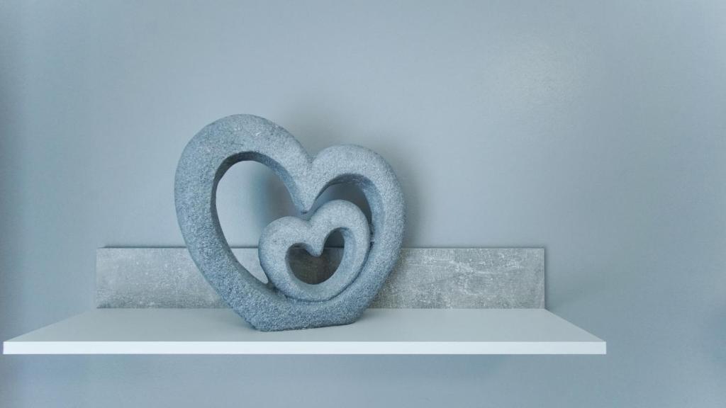 a sculpture of a heart sitting on a shelf at Apartmány Monty in Karlovy Vary
