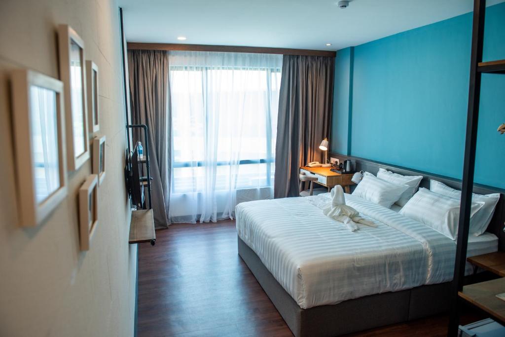 Postel nebo postele na pokoji v ubytování O&G Hotel Parit Buntar