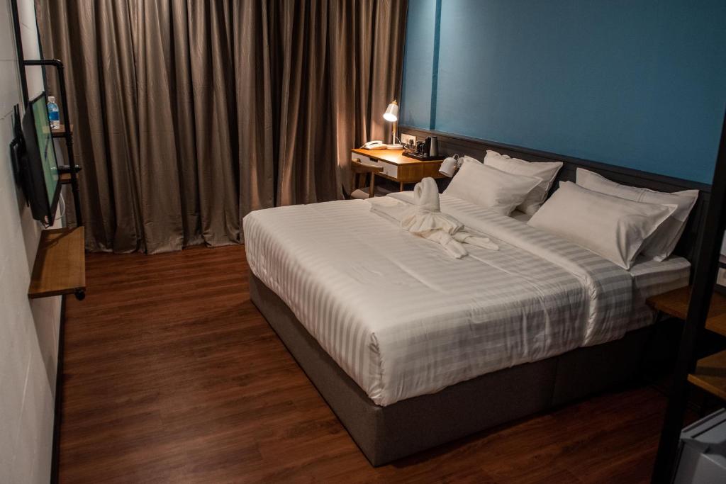 Postel nebo postele na pokoji v ubytování O&G Hotel Parit Buntar