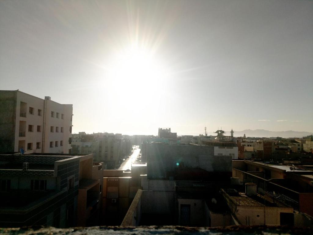 a view of a city with the sun in the sky at Mustapha 3 in Nador