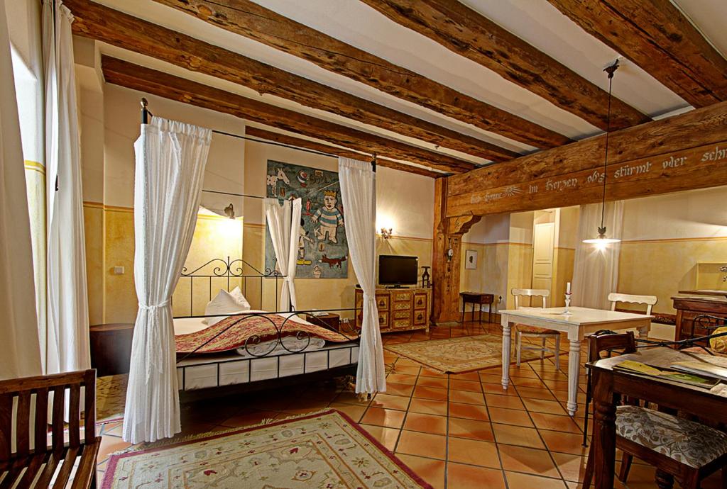 a bedroom with a bed and a table in a room at Hotel Orphée Andreasstadel in Regensburg