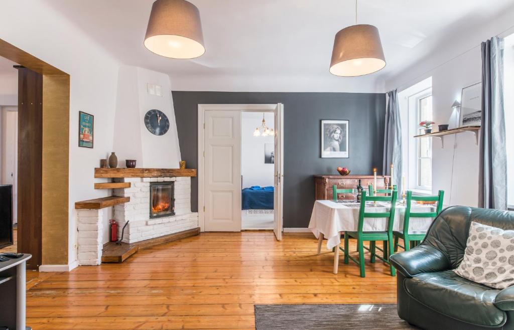 a living room with a table and a fireplace at Old City Park Apartment in Rīga