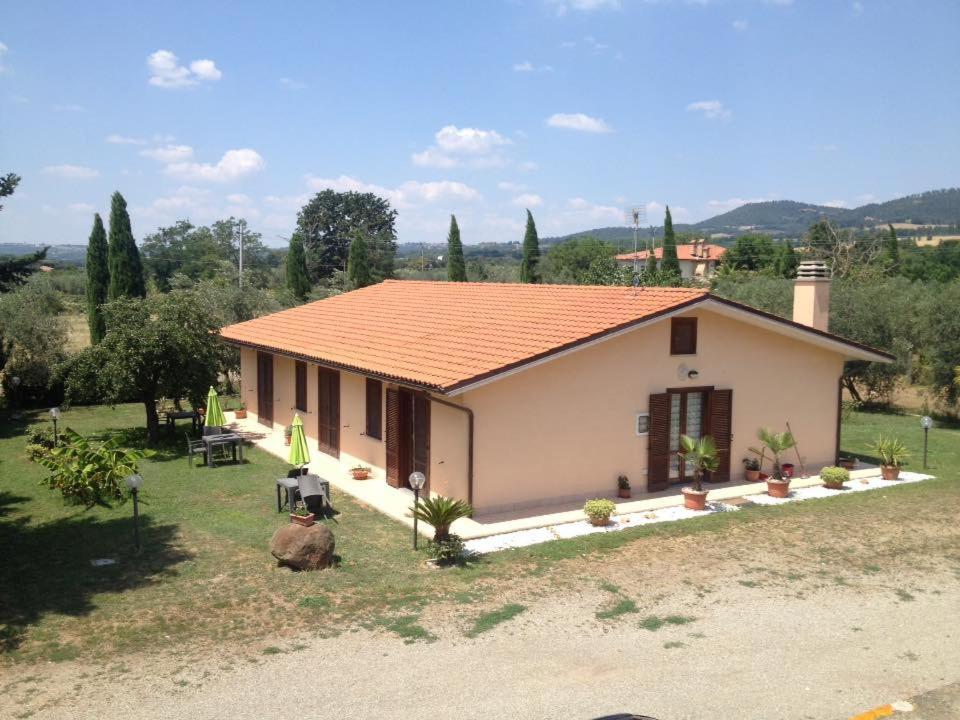 a small white house with an orange roof at Agriturismo La Piantata in Bolsena