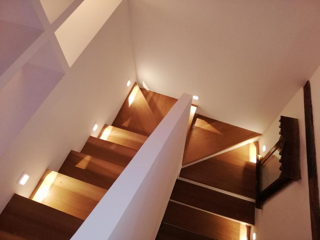 una escalera en una casa con suelo de madera y luces en Apartamento Zocailla Suite, en Gata