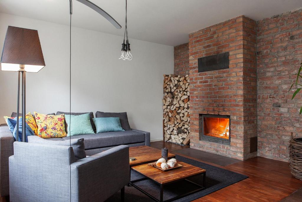 a living room with a couch and a fireplace at Apartament Sopot 10 in Sopot