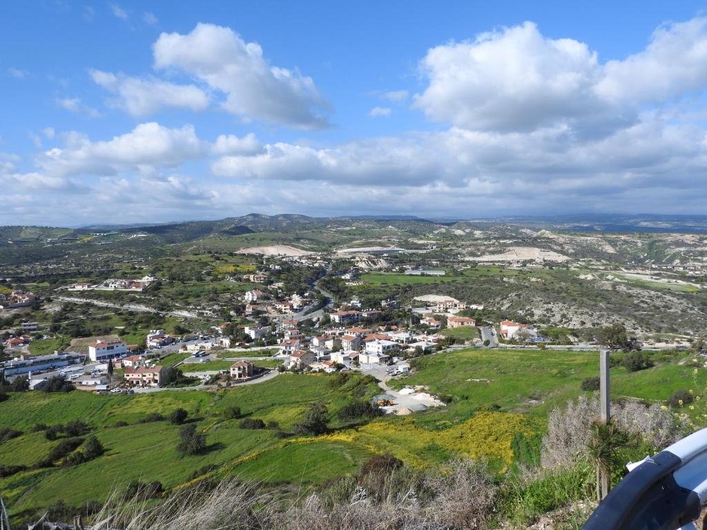 a view of a small town on a hill at Hill View Hotel Apartments in Pissouri