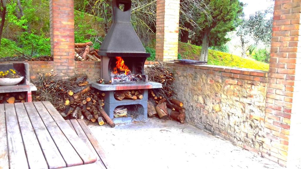 a fire pit with a grill on top of it at Residence Le Meridiane in Siena