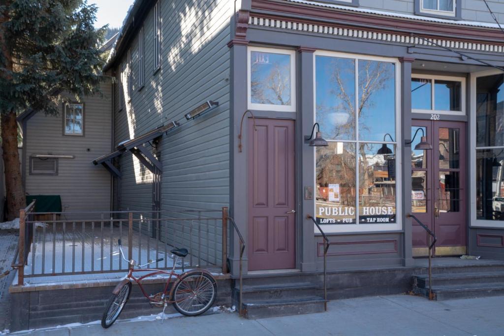a bike is parked outside of a building at Public House Lofts in Crested Butte