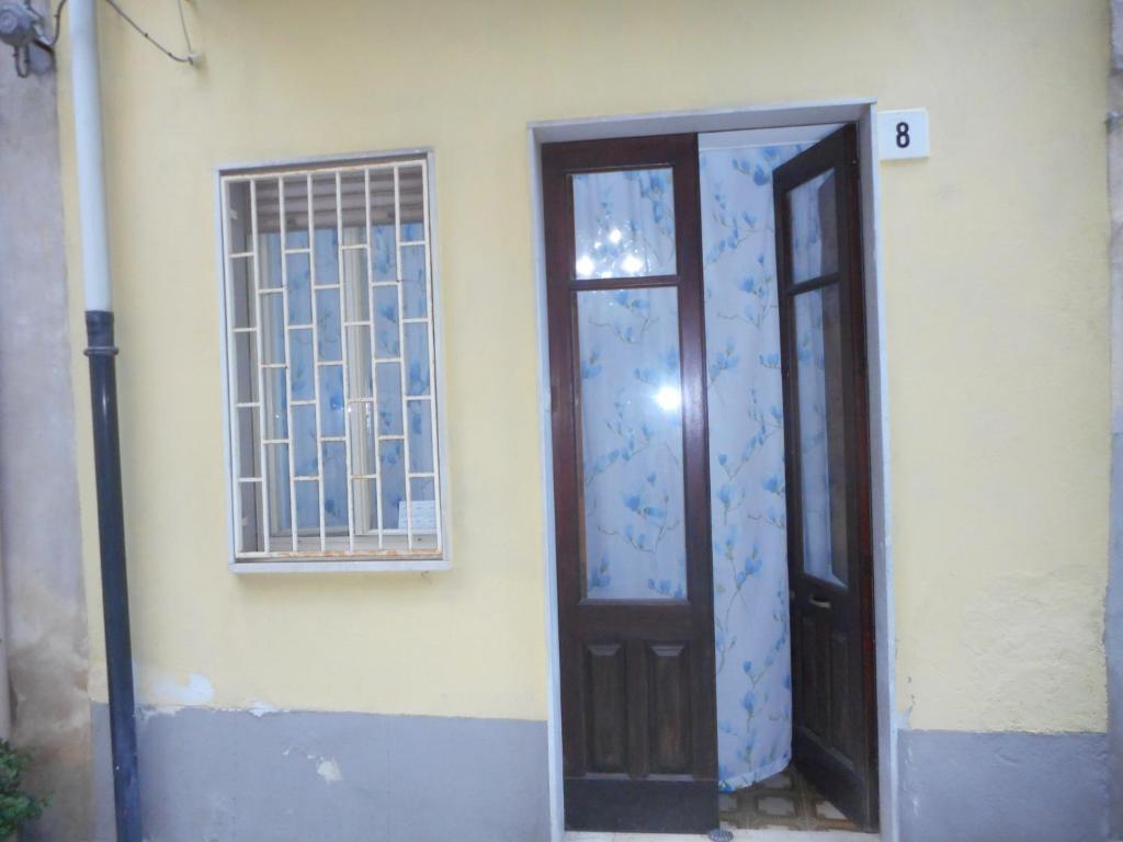 a door of a house with a window and a door at Casa di Rosa in Francavilla di Sicilia