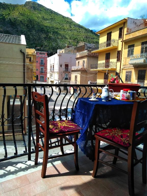 a table and two chairs sitting on a balcony with a table at Home Vivaldi in Castellammare del Golfo