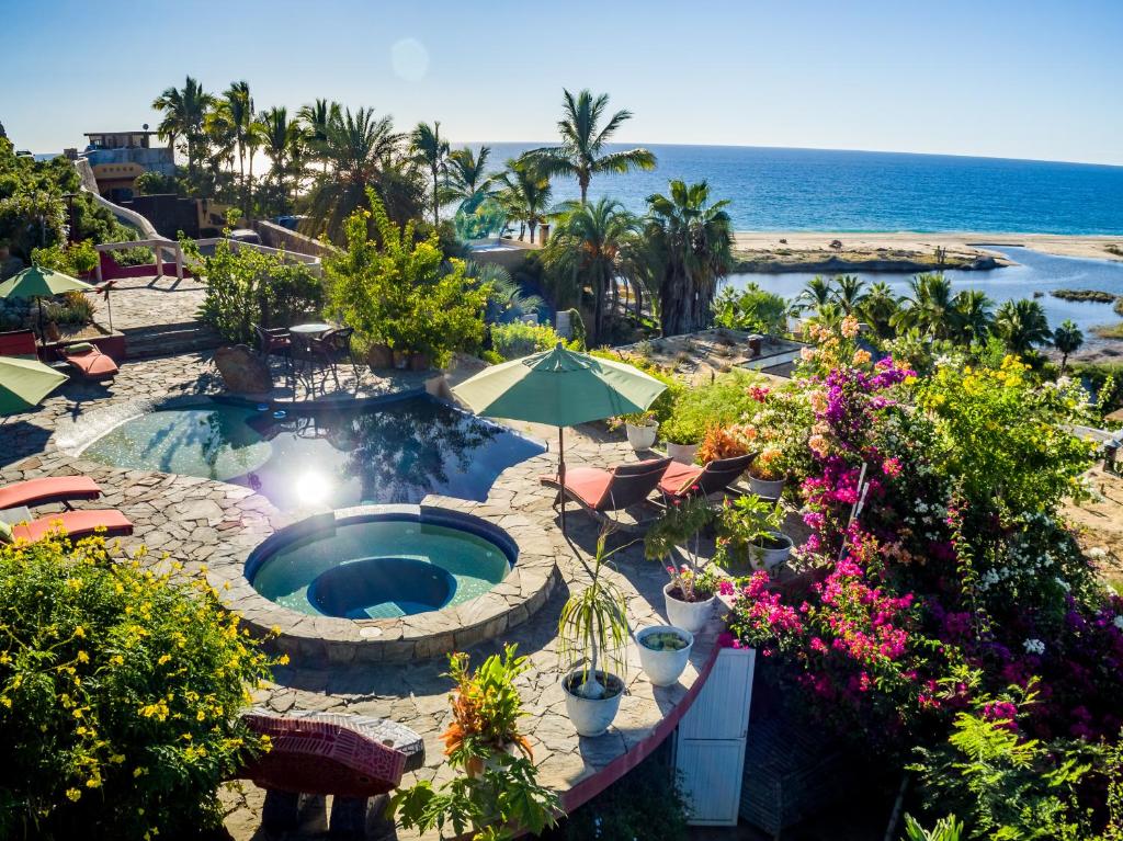 a view of a swimming pool and the beach at Los Colibris Casitas in Todos Santos
