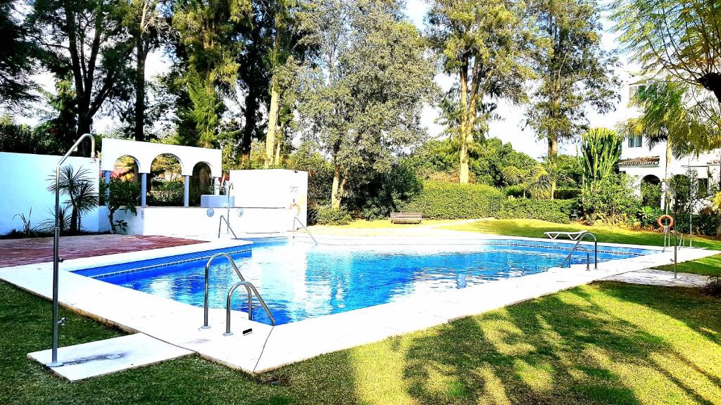 a swimming pool in the yard of a house at Apartamento con vistas al Campo de Golf y Piscina in Mijas Costa