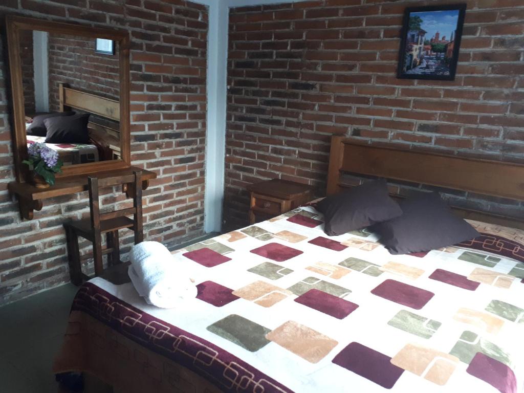 Postel nebo postele na pokoji v ubytování La Misión Cabañas Chignahuapan