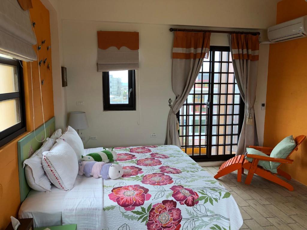 a bedroom with a large bed with flowers on it at Remember Sea View B&amp;B in Huxi