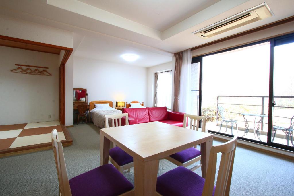 Postel nebo postele na pokoji v ubytování Stardust Village Hossyo