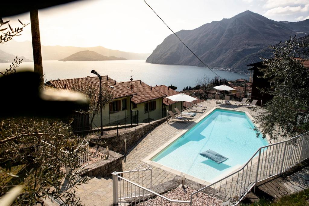 a swimming pool with a view of a lake at Hotel Miranda in Riva di Solto