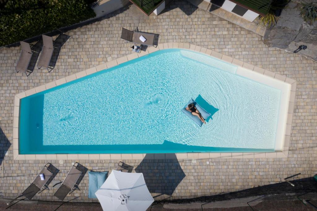 an overhead view of a person in a swimming pool at Hotel Miranda in Riva di Solto