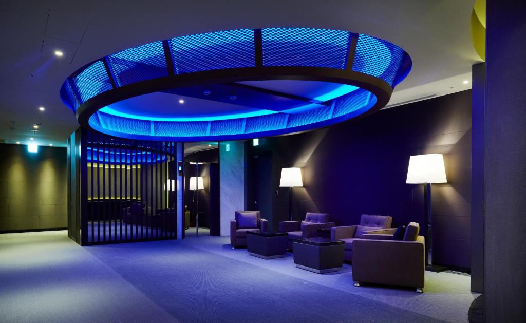 a lobby with purple chairs and a blue ceiling at The Tango Taichung in Taichung