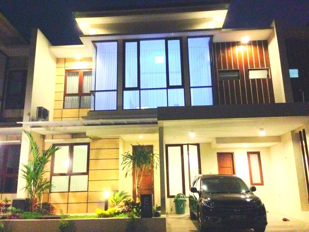 a car parked in front of a house at night at Fams Homestay by FH Stay in Yogyakarta