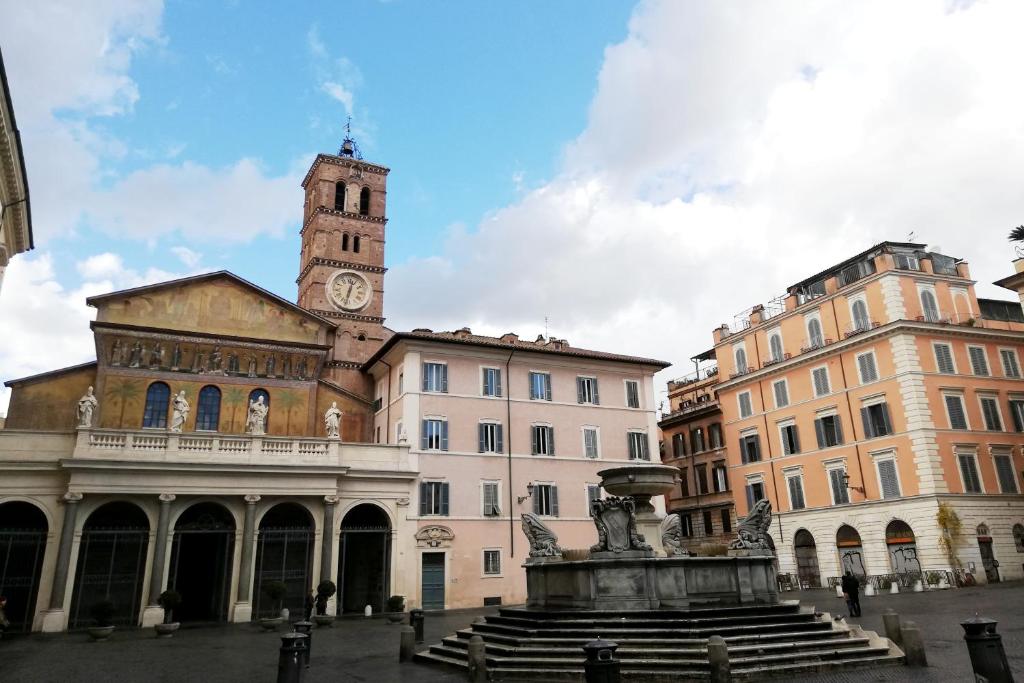 a building with a clock tower on top of it at Luxury Trastevere in Rome