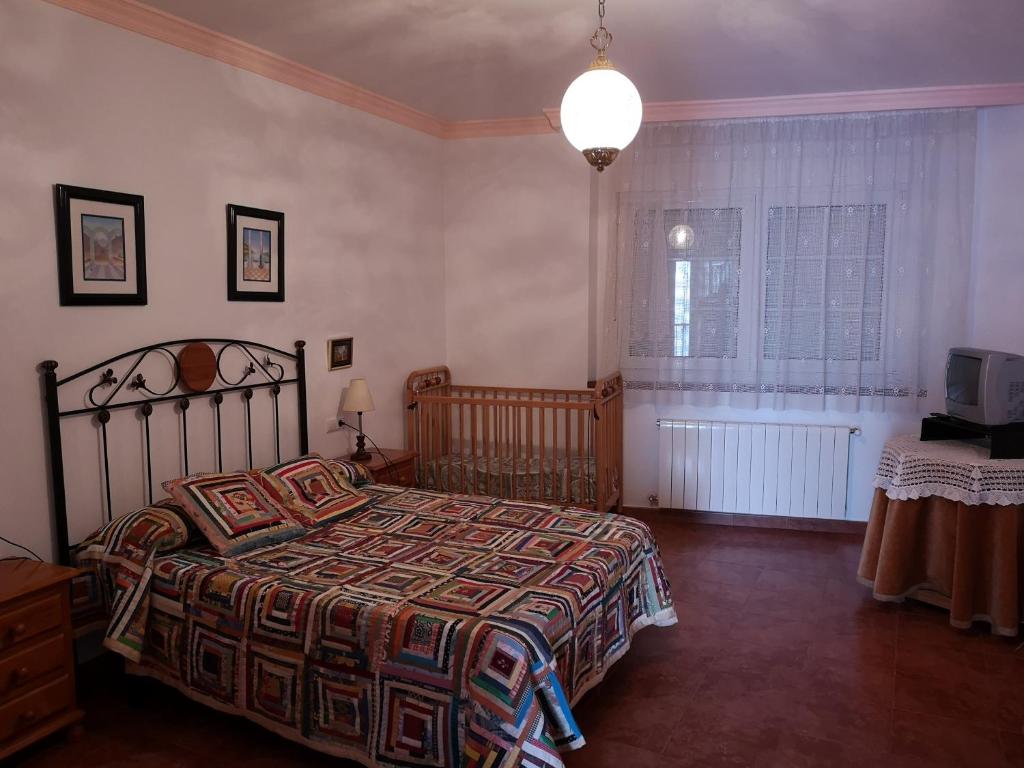 a bedroom with a bed and a television in it at Villa Remedios in Cuevas del Becerro