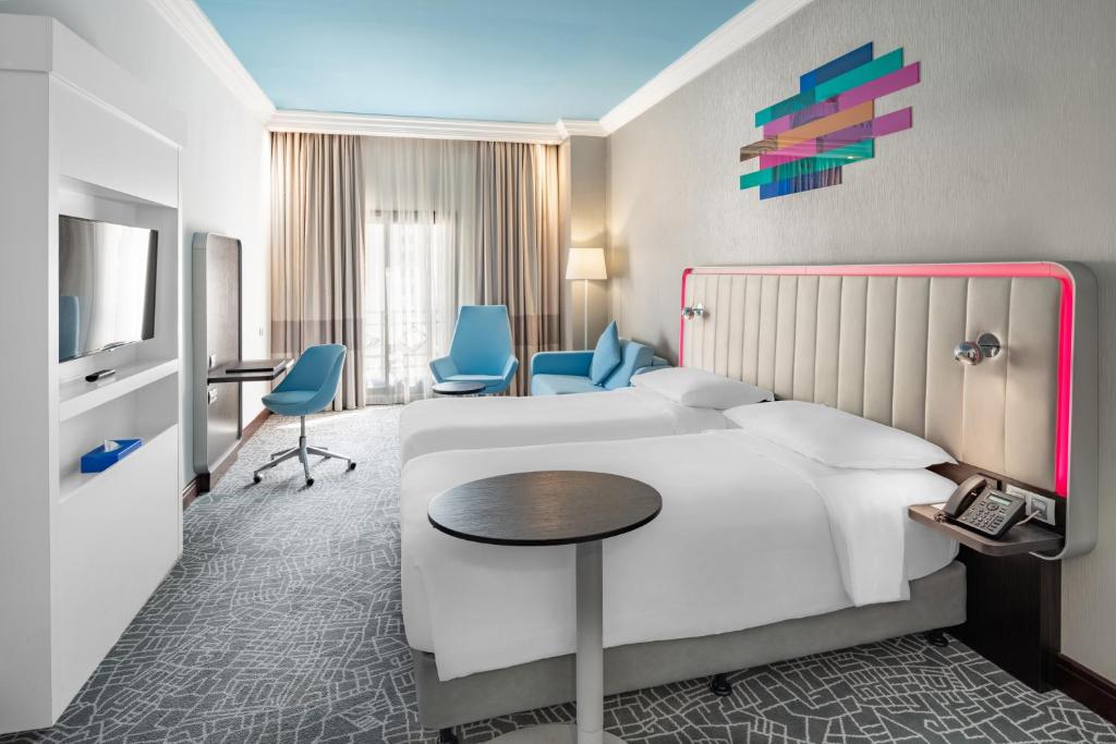 Postel nebo postele na pokoji v ubytování Park Inn by Radisson Makkah Al Naseem