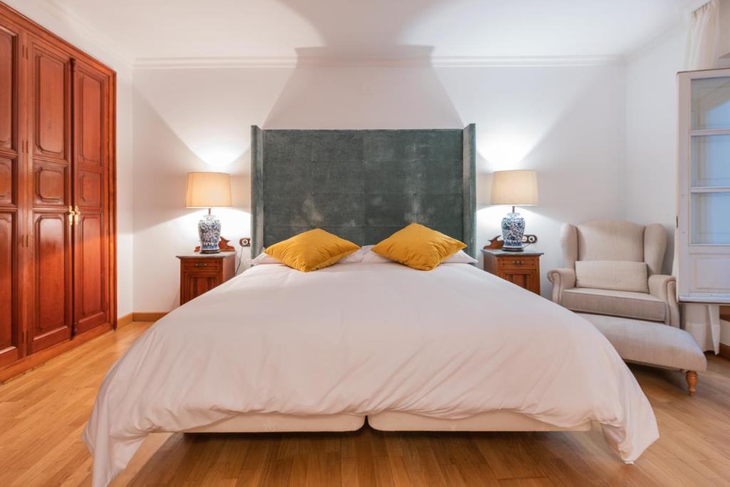 a bedroom with a large bed and a large window at CASA MIRAFLORES in Málaga