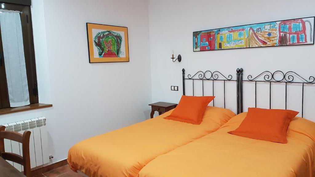 two beds sitting next to each other in a room at La Aldea Colorada in Mota del Marqués
