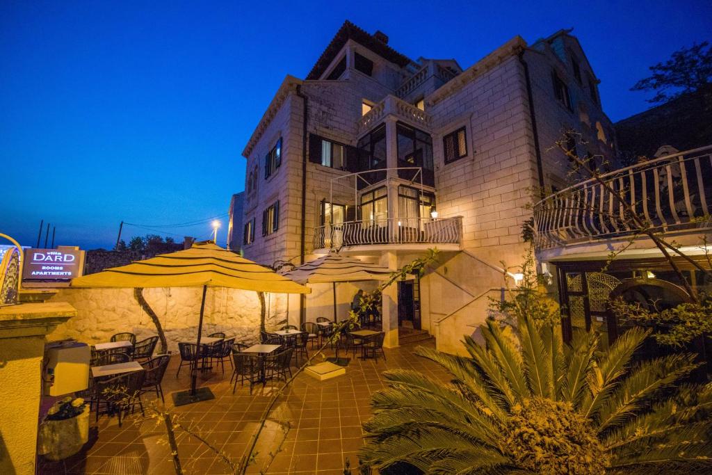 
a large building with a patio and a balcony at Villa Dard in Dubrovnik
