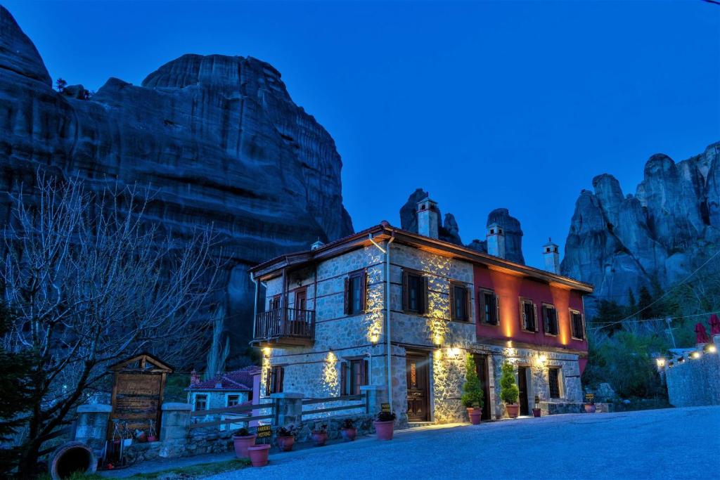 an old building with christmas lights on it at night at Petrino Guesthouse in Kalabaka