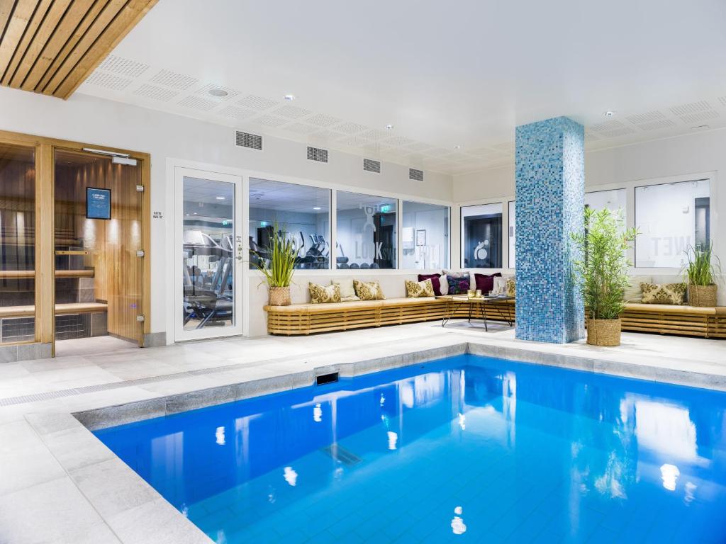 a swimming pool in a house with a living room at Clarion Hotel Winn in Gävle