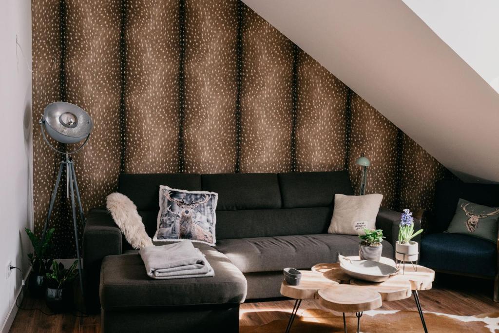 a living room with a couch and a table at JAM Luxury Apartment in Győr